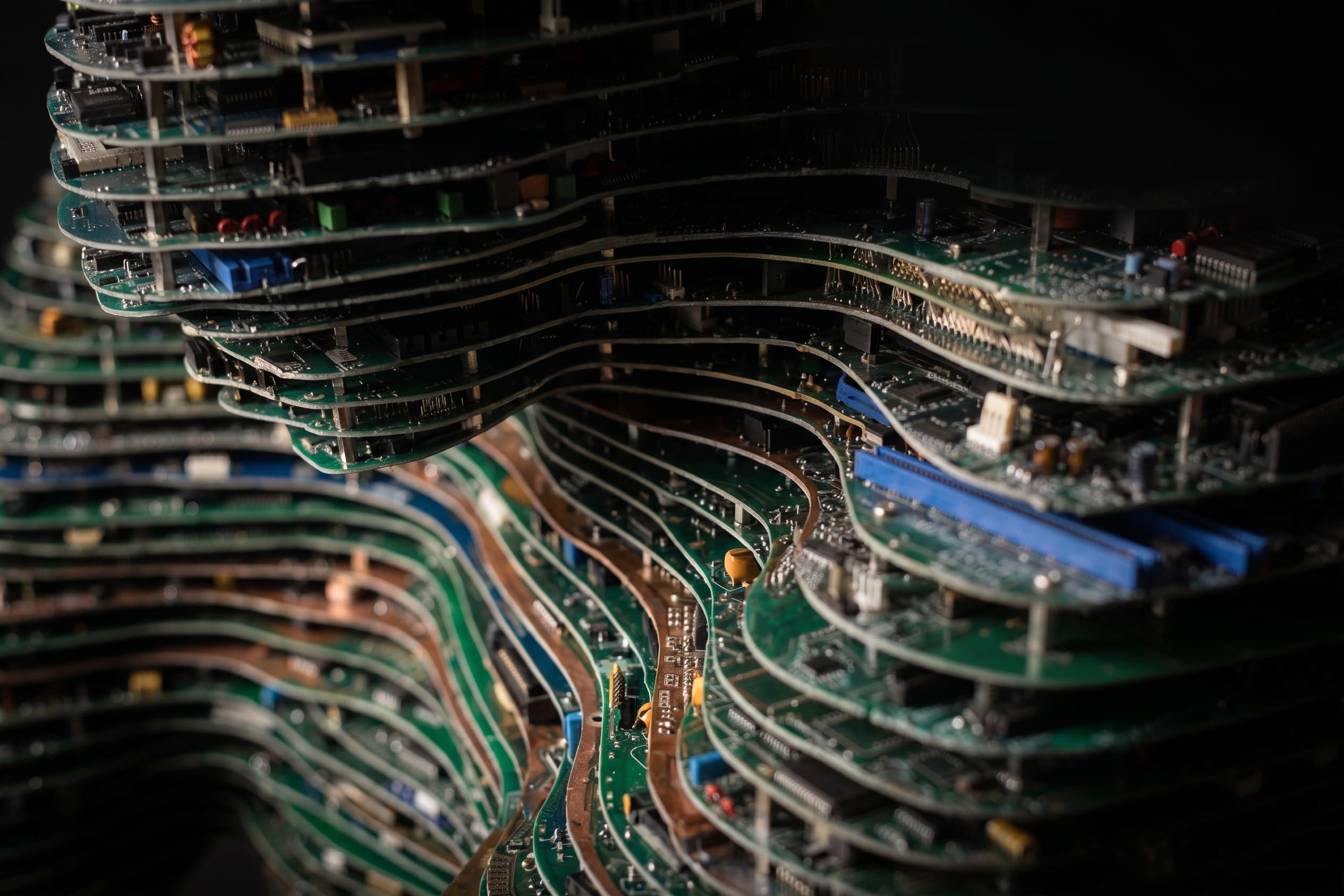 Detail of a sculpture built from stacked circuit boards cut into a wave